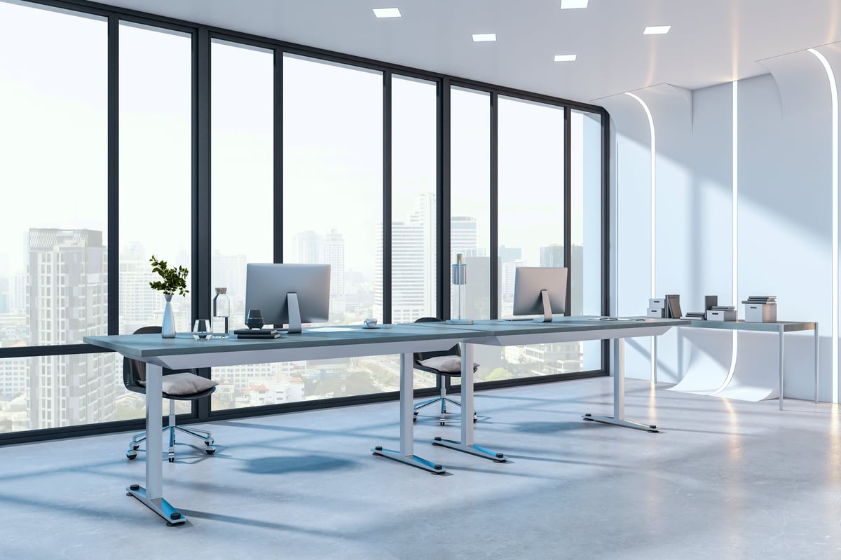 Modern office interior with sleek desks, computers, and accessories