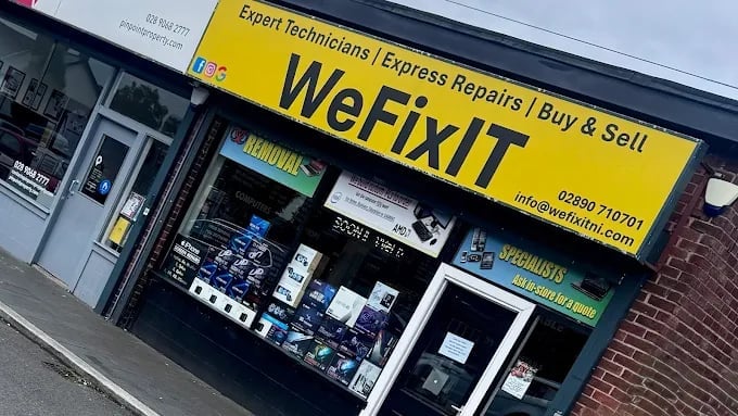 Storefront of WeFix IT repair shop with yellow signage displaying services including expert technicians, express repairs, and buy and sell options