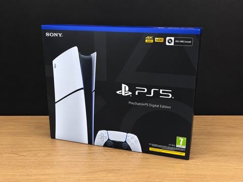 PlayStation 5 Digital Edition retail box showing console and white controller on wooden surface